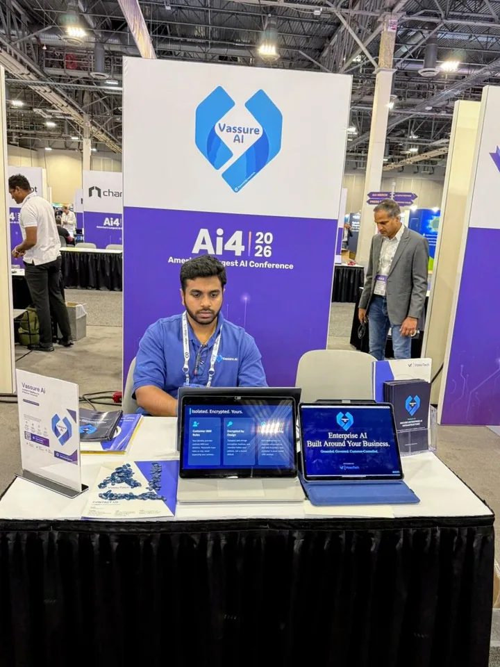 Jaya Sriram Ganeshna at the Vassure Ai exhibition table, with product screens and branded signage at Ai4
