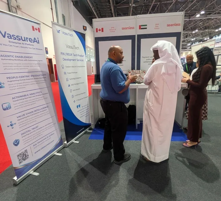 The Vassure Ai team speaking with visitors beside Vassure Ai and VassuTech banners at the Seamless Middle East exhibition booth